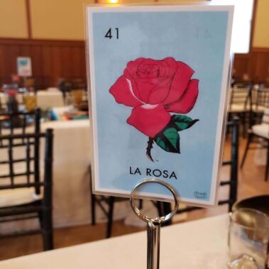 Close up of table card with a red rose